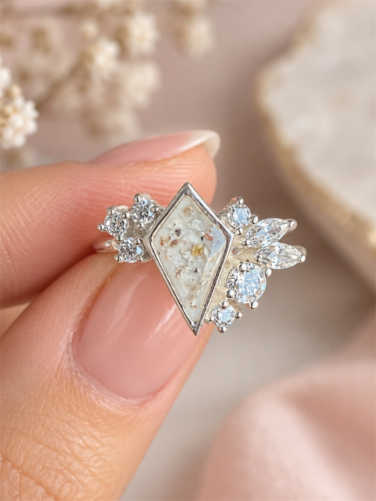 Silver ashes keepsake ring with a kite-shaped memorial stone and sparkling clear gemstones.