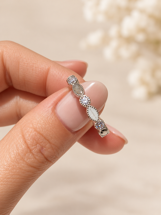 Ring containing ashes and hair in sterling silver with clear cubic zirconia gemstones.