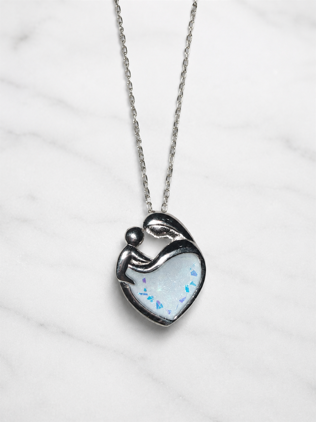 A mother and baby pendant encased with breastmilk. 