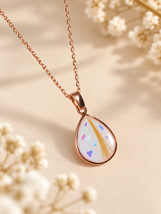 Breastmilk keepsake necklace containing preserved breastmilk and a lock of hair