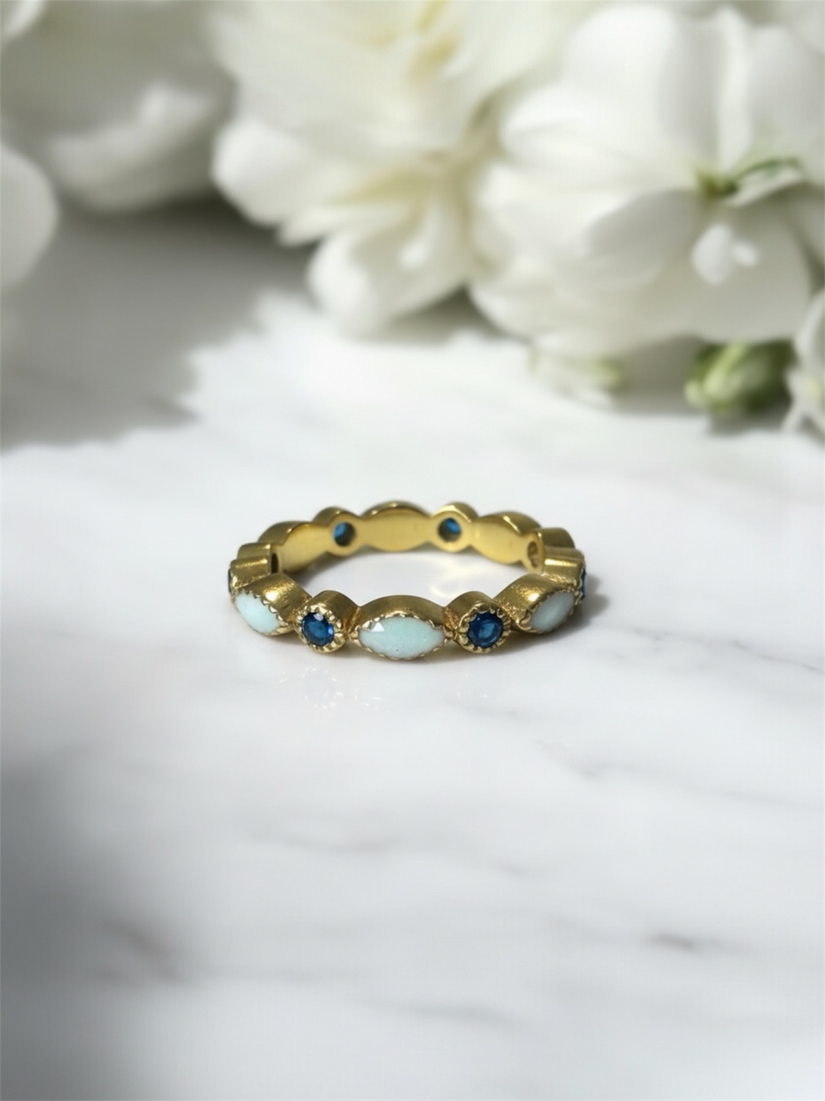 yellow gold ring with birthstones with preserved breastmilk encased. 