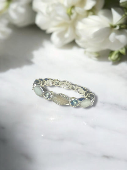 A sterling silver ring containing hair and preserved breastmilk. 