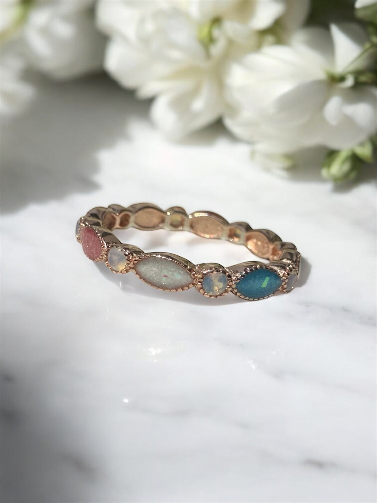 Breastmilk ring in rose gold customised with birthstones. 