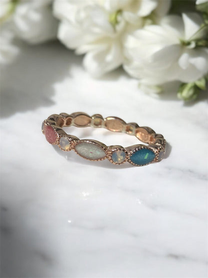 Breastmilk ring in rose gold customised with birthstones. 