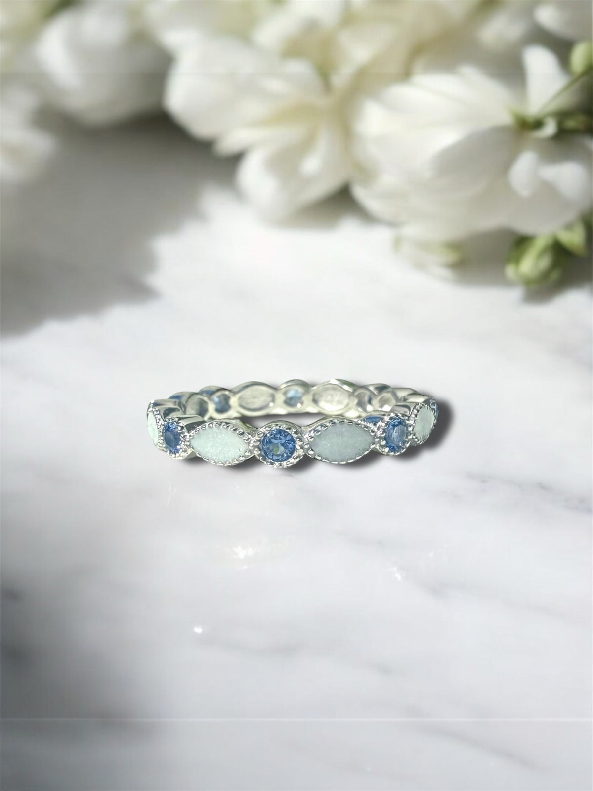 Preserved breastmilk ring set in sterling silver with customised birthstones. 